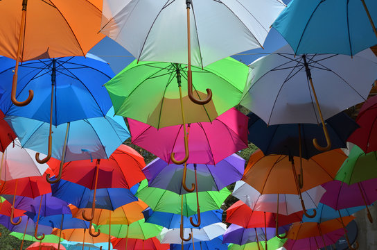 Opened umbrellas of different colors shot from underneath