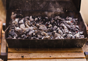 Smoldering Charcoal under barbecue grill ready to prepare grilled meat.