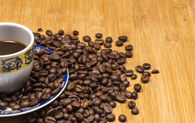 Coffee cup and coffee beans on a wooden table