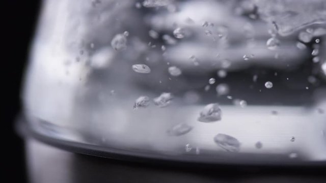 Water Boiling and Bubbling in Glass Kettle, Macro