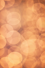 Christmas shiny bokeh in yellow golden colors, new year illunination. Seasonal vintage hipster holiday background.