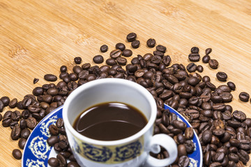 Coffee cup and coffee beans on a wooden table