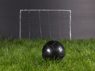 black soccer ball on the grass