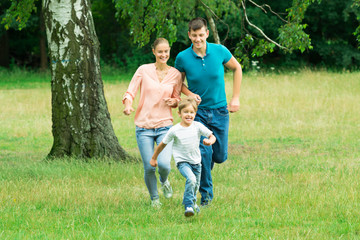 Fototapeta premium Boy Running Ahead Of His Parent