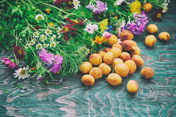 Bouquet of fresh summer flowers on the blue wooden grunge desk with apricot fruits. Background in vintage hipster eco rustic style with copy space