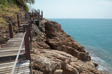 Wooden bridge on a rock by the sea