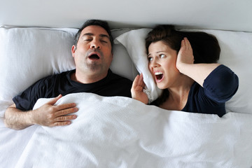 Woman suffers from her partner snoring in bed