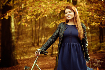 Fototapeta na wymiar Girl in dress on bike.