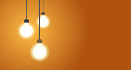 Three hanging light bulbs glowing on yellow background with copy space