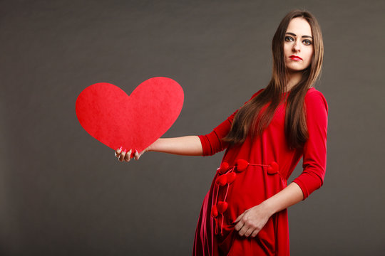 Girl holding red heart love sign