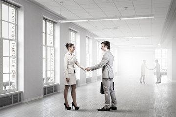 Fototapeta premium Business partners handshake . Mixed media