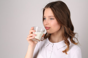 Girl drinking milk. Close up. White background