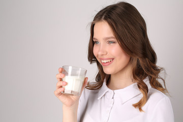 Lady with glass of milk. Close up. White background