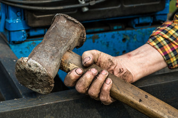 Hand holding a big hammer. Sledgehammer.