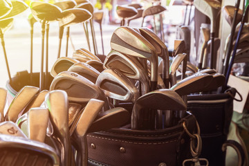 metal golf clubs set in leather bag in the morning
