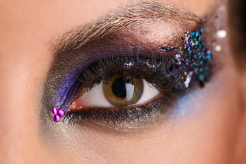 Eye makeup with colorful crystals. Close up