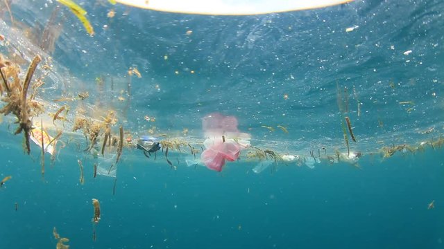 Plastic pollution in ocean. Plastic bags and bottles pollute the sea