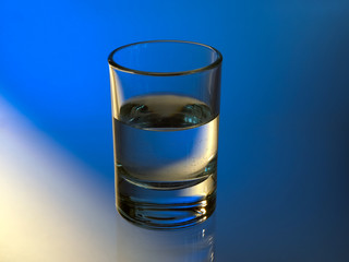 Beautiful glass with vodka. Blue yellow light