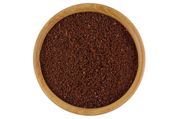 Top view of Ground coffee powder in a wooden bowl isolated on white background