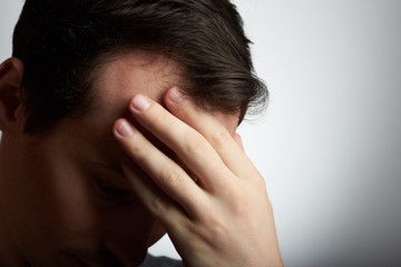 man hiding his face