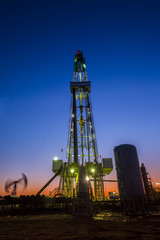 oilfield derrick at night