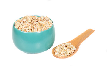 oats flakes pile in bowl on wood background.
