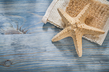 Composition of starfish wisp bast on wooden board healthcare concept