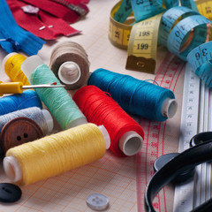 Sewing tools and accessories on graph paper