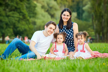 Fototapeta premium Happy family in the park summer, autumn. Parents and two daughte
