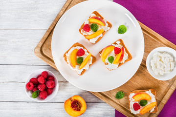 Raspberry Mascarpone Peach Bruschetta decorated with mint leaves