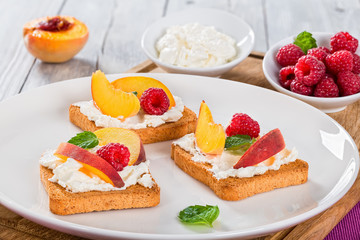 Raspberry Mascarpone Peach Bruschetta toasts on  dish