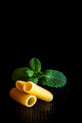 Italian pasta, macaroni, on black background