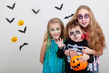 Happy brother and two sisters on Halloween party