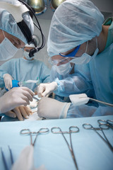 Four surgeons working in operating room
