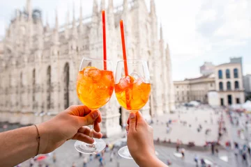 Fotobehang Clinking glasses of spritz aperol drink on the main square with Duomo cathedral on the background in Milan city © rh2010