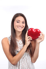 Pretty young woman holds red heart for Love