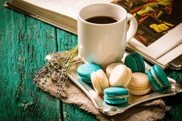 Fototapeta premium fresh macaroons and tea cup on wooden table .Vintage filter
