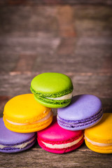 Fresh macaroons on wooden table ,vintage filter
