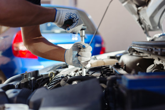 Mechanic working in auto repair garage. Car maintenance