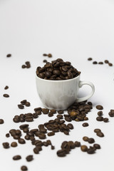 Coffee cup filled with coffee beans.