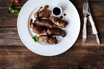 beef stuffed with mushrooms in a bowl on a wooden table