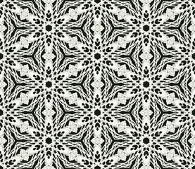 Black and white monochrome seamless pattern background made of repeating scanned elements of handmade crochet lace