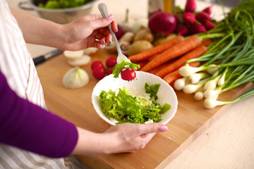 Young Woman Cooking in the kitchen. Healthy Food