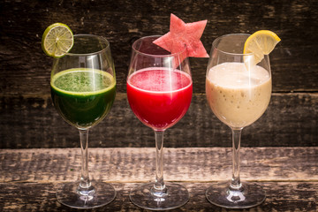 Fresh red and green smoothie on vintage wooden background.Healthy detox drink