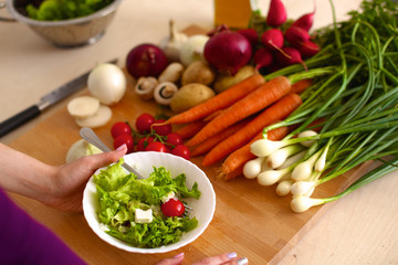 Young Woman Cooking in the kitchen. Healthy Food