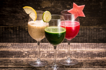 Fresh red and green smoothie on vintage wooden background.Healthy detox drink