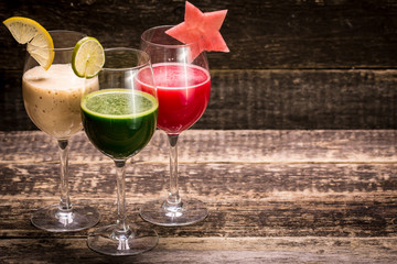 Fresh red and green smoothie on vintage wooden background.Healthy detox drink