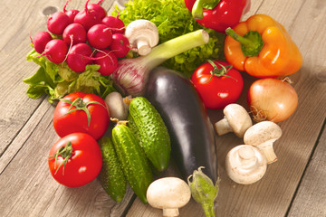 Composition with assorted raw organic vegetables wooden table