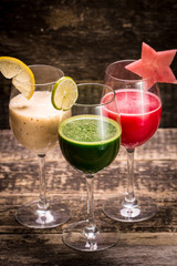 Fresh red and green smoothie on vintage wooden background.Healthy detox drink