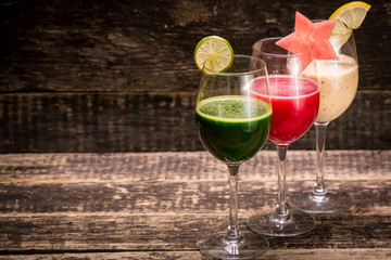 Fresh red and green smoothie on vintage wooden background.Healthy detox drink